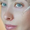 li-woman-applying-facial-serum-dropper-skincare-routine